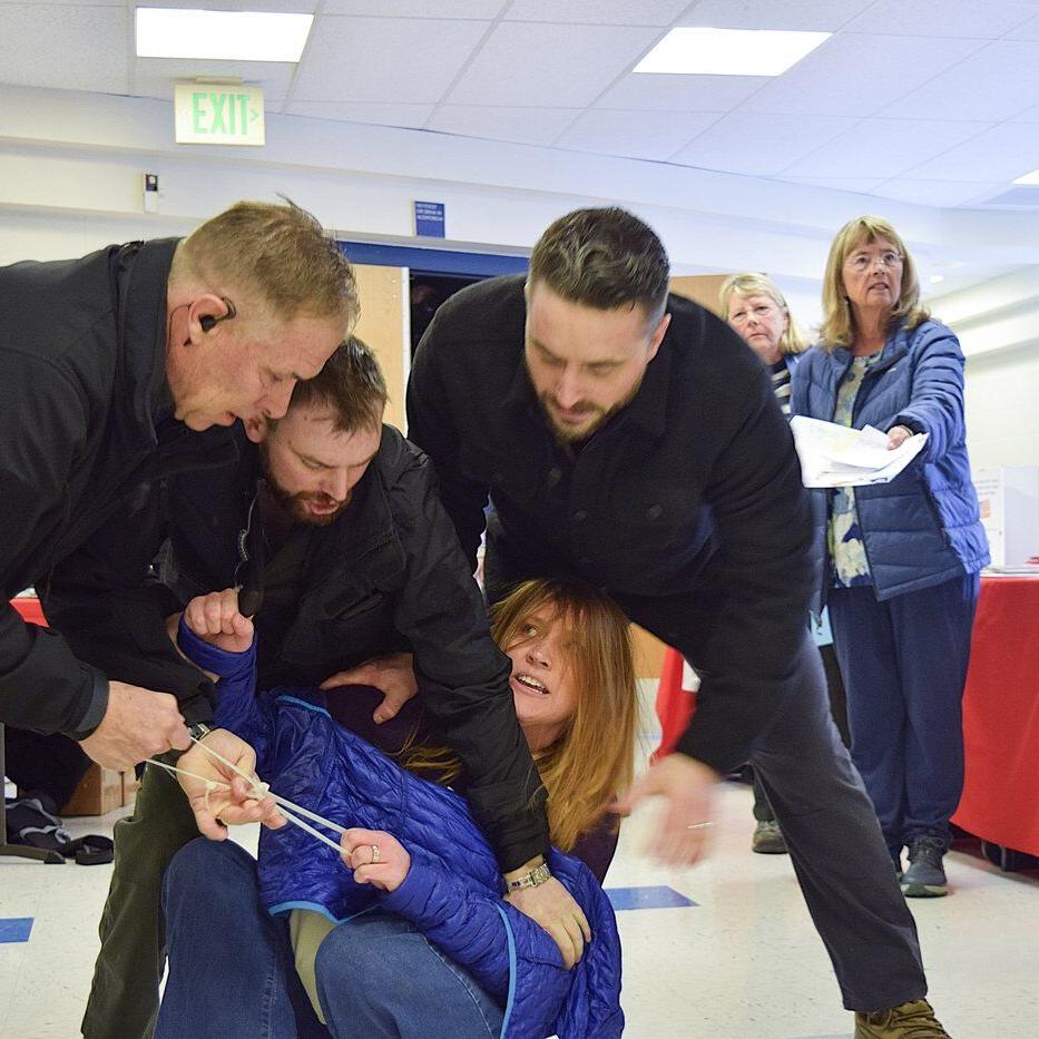 Private security guards charged after woman was dragged out of chaotic Idaho town hall meeting